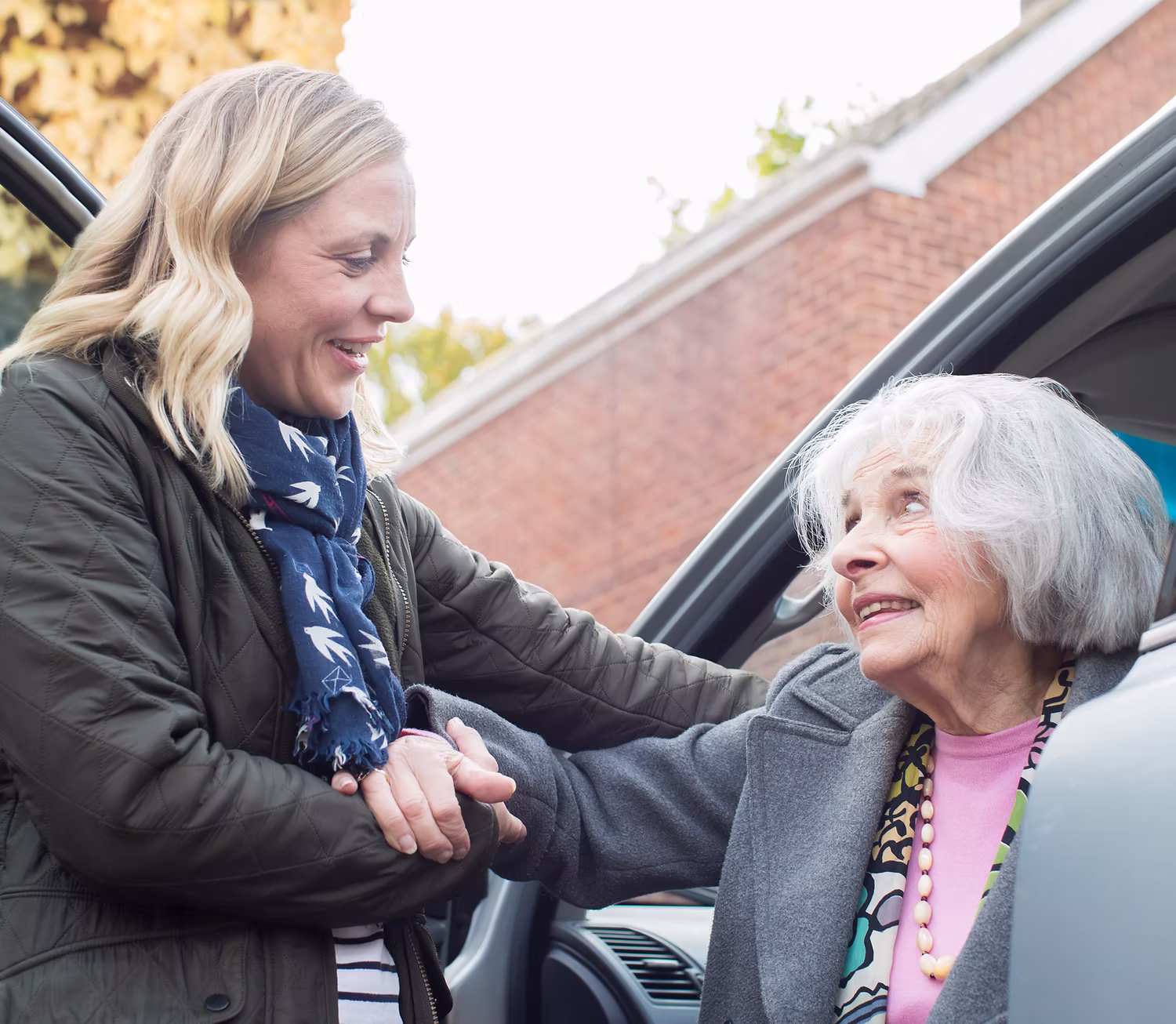 Younger person assisting older individual.