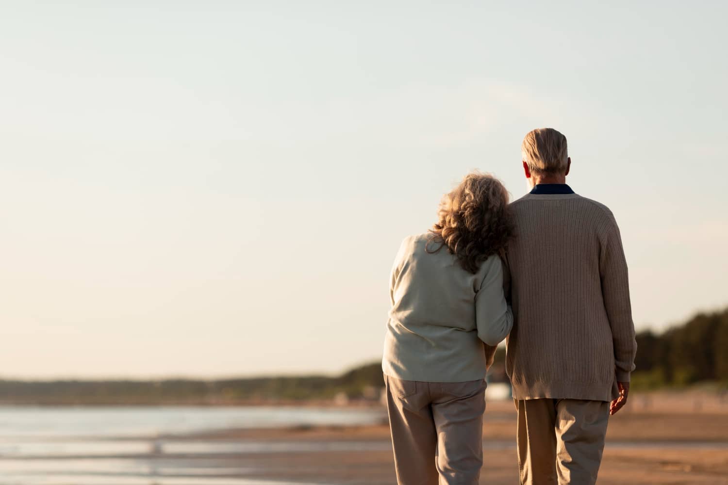 Elderly couple walking on beach
