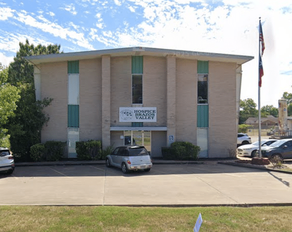 Hospice Brazos Valley - Brenham Office Contact Building with hospice sign and flag