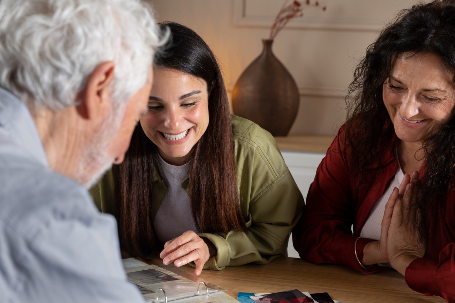 Two women reviewing photographs together.