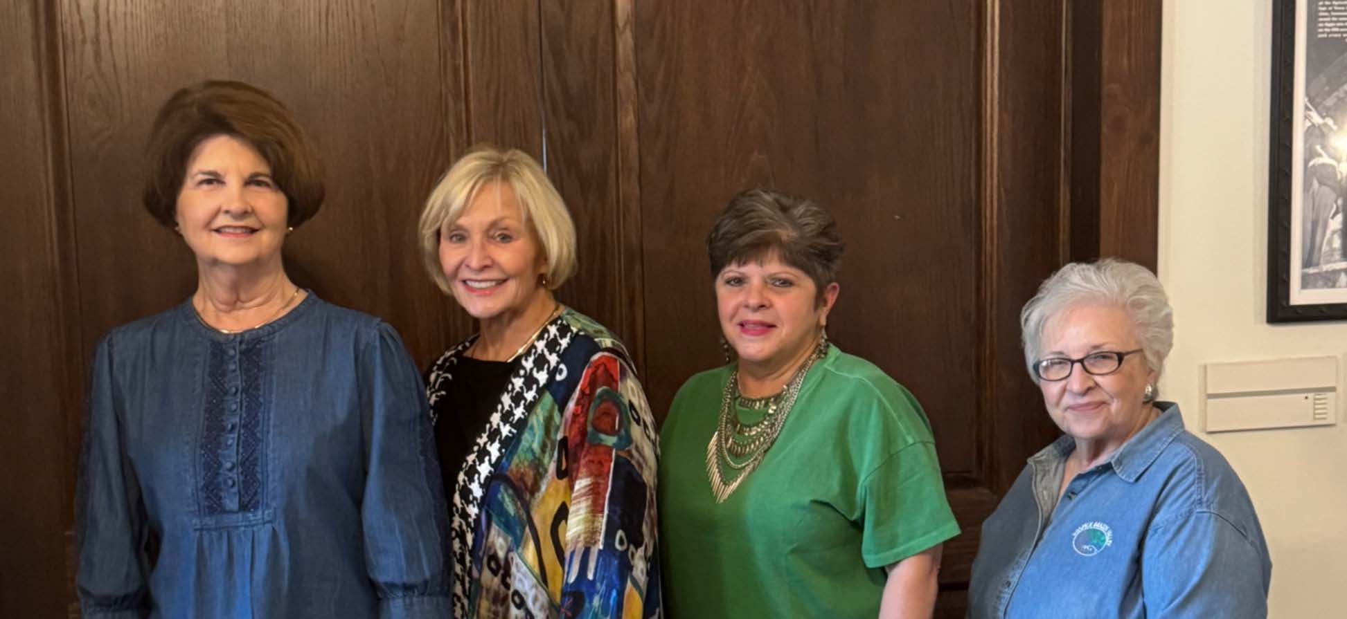 Hospice Brazos Valley - Hospice Auxiliary Group of women posing together indoors.